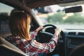 Young woman beginner driving a car, back view Royalty Free Stock Photo