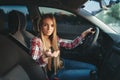 Young woman beginner offers a ride on car