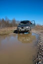 Young woman behind rudder of offroad car on dirt r Royalty Free Stock Photo