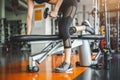 Young woman bench pressing with dumbbells in fitness gym. Working triceps and chest weight lifting. Sport and workout exercise