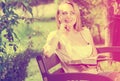 Young woman on bench reading book Royalty Free Stock Photo