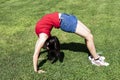 Young Woman Bending Over Backwards On Green Grass Royalty Free Stock Photo