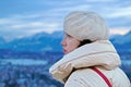 Young woman in a beret is dreaming on the top of Drakensberg mountain in Hohensalzburg Fortress, Salzburg, Austria. Beautiful view