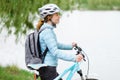 Young woman with bicycle. Beautiful woman walking in the park
