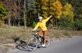 young woman on a bicycle rides in an autumn park on a sunny day Royalty Free Stock Photo