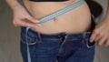 Young Woman In Big Blue Jeans. Large Size After Losing Weight. Girl Weight Loss.