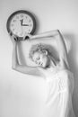 Young woman with big clock in hands.