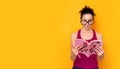 Young woman with big glasses holding a book