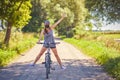 Young woman on a bike in countryside wearing a mask Royalty Free Stock Photo