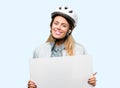 Young woman with bike helmet and earphones over blue background
