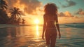 Young woman in bikini, african american model standing back on the beach at sunset Royalty Free Stock Photo