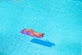 Young woman in bikini air mattress in the big swimming pool Royalty Free Stock Photo