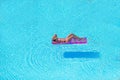 Young woman in bikini air mattress in the big swimming pool Royalty Free Stock Photo