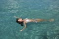 Young woman in bikini floating in water Royalty Free Stock Photo