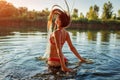 Young woman in bikini jumping out of water and making splash. Summer vacation Royalty Free Stock Photo