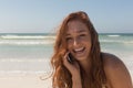 Young woman in bikini talking to her mobile phone at beach Royalty Free Stock Photo