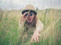 Young woman with binoculars in the grass Royalty Free Stock Photo