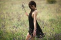 A young woman collecting wildflowers in the meadow Royalty Free Stock Photo