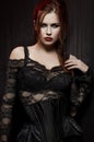 Young woman in black gothic costume