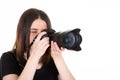 Young woman with black professional digital SLR camera on white background Royalty Free Stock Photo