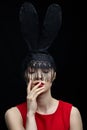 Young woman in black rabbit or hare fancy mask and red dress Royalty Free Stock Photo