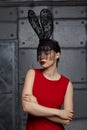 Young woman in black rabbit or hare fancy mask and red dress Royalty Free Stock Photo