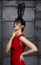 Young woman in black rabbit or hare fancy mask and red dress Royalty Free Stock Photo
