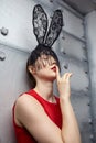 Young woman in black rabbit or hare fancy mask and red dress Royalty Free Stock Photo