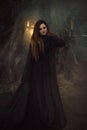 A young woman in black robe with long hair looking directly at c Royalty Free Stock Photo