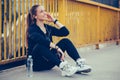Young woman in black sports outfit taking break after running on the bridge Royalty Free Stock Photo