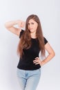 Young woman in black t-shirt showing thumb down gesture  on white background Royalty Free Stock Photo