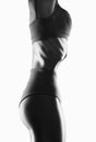 Young woman in black and white sportswear working out her abdominal muscles. Beautiful sporty woman is exercising and doing Royalty Free Stock Photo
