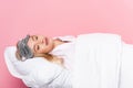 Woman in blindfold sleeping on pillow