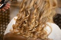 Young woman blond curly getting beautiful hairstyle in hair salon hairdresser Royalty Free Stock Photo