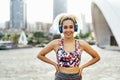 Young woman with blond curly hair doing sport outdoor while listening music playlist - Fit girl doing morning workout - Fitness, Royalty Free Stock Photo