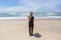 Young woman with blond dreadlocks standing on the ocean coast. Royalty Free Stock Photo