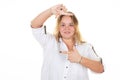 young woman with blond long hair mimics virtual empty frame with fingers on white background