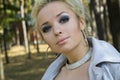 Young woman blonde on a background trees in a park