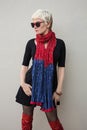 Young woman blonde in fashion black little dress, red scarf, sunglasses. Royalty Free Stock Photo