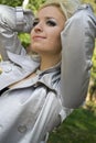 Young woman a blonde smiles on a background trees