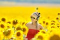 Young woman on blooming sunflower field