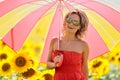 Young woman on blooming sunflower field