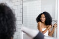 A young woman blow drying her hair Royalty Free Stock Photo