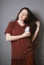 Young woman blow-drying her long hair with blow dryer Royalty Free Stock Photo