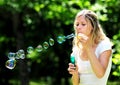 Young woman blowing bubbles Royalty Free Stock Photo