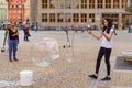 Young woman blowing bubbles on the Market Square in Wroclaw