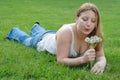 Young woman blowing dandelions