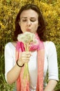 Young woman blowing on dandelions Royalty Free Stock Photo