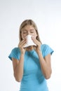 Young woman blowing her nose with kleenex Royalty Free Stock Photo