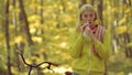 Young woman blowing nose at nature. Young woman with handkerchief. Woman makes a cure for the common cold.